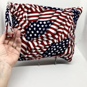 eleven by thirteen inch project bag handcrafted with American flag print upcycled fabric. Zipper is included with an accessible handle which makes it easier to open and closer. The lining is a light color which helps to see the interior more easily.