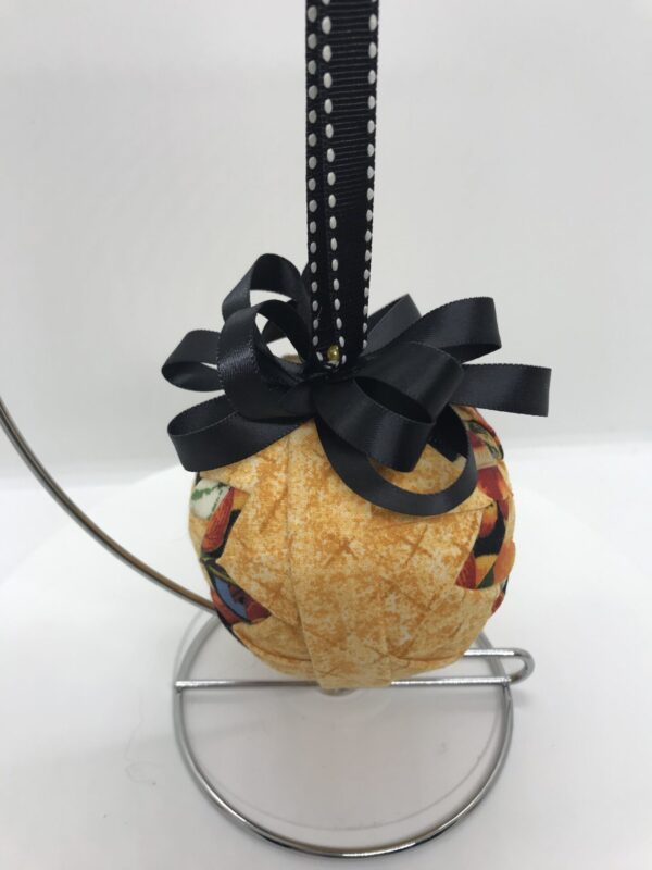 Side View Golden 3" Round Ornament with Basic Star Pattern with fruit printed fabrics, black bow and hangerjpeg