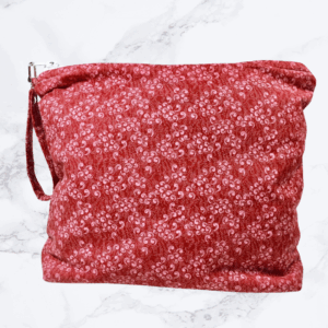 Large project bag with cranberry calico fabric and zipper closure at the top with an accessbile handle attached to the zipper.