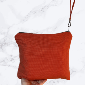 Burnt orange eleven by 13 inch zipper bag with accessible handle on zipper