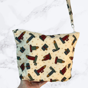 Eleven by thirteen inch large project bag handcrafted with a candle print on cream background with zipper. An accessible handle is attached to the zipper.