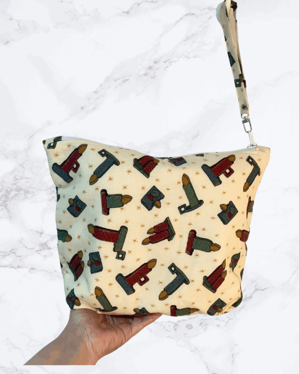 Eleven by thirteen inch large project bag handcrafted with a candle print on cream background with zipper. An accessible handle is attached to the zipper.