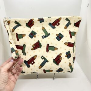 eleven by thirteen inch project bag handcrafted with an candle print upcycled fabric. Zipper is included with an accessbile handle which makes it easier to open and closer. The lining is a light color which helps to see the interior more easily.