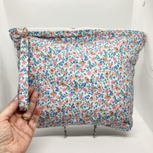 Eleven by thirteen inch project bag handcrafted with pale blue with butterflies upcycled fabric. Has a zipper closure with an accessible handle attached to the zipper.