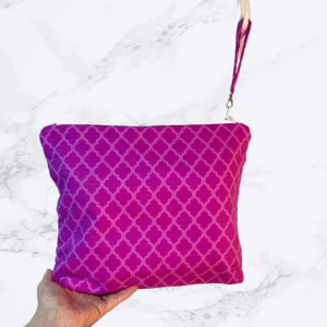 Eleven by thirteen inch project bag handcrafted with a fuschia diamond pattern. Has a zipper closure with an accessible handle attached to the zipper.